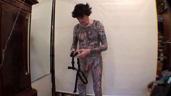 Tattoo Boy LeeHarper Pinnomen Show Off With a Borrowed Fancy Tight Beltstrap used in the Male Stripshow Production – Two Rings are Attached to the Strap – Enabling a Stripper With a P/A to Suspend His Penis Almost Resembling the Look of Aboriginals in PNG